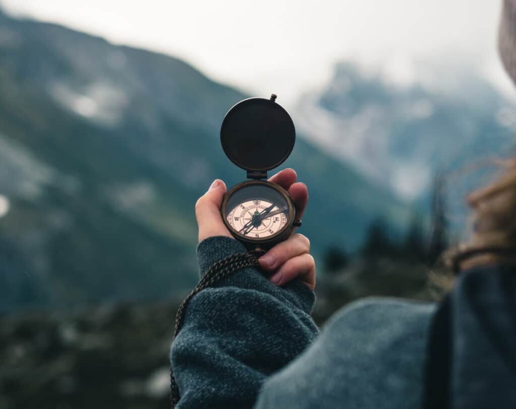 Woman Holding Compass. Don't Start Marketing Until You've Defined Your Goal